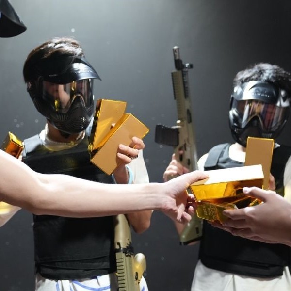 Wargamers at War Zone holding gold bars