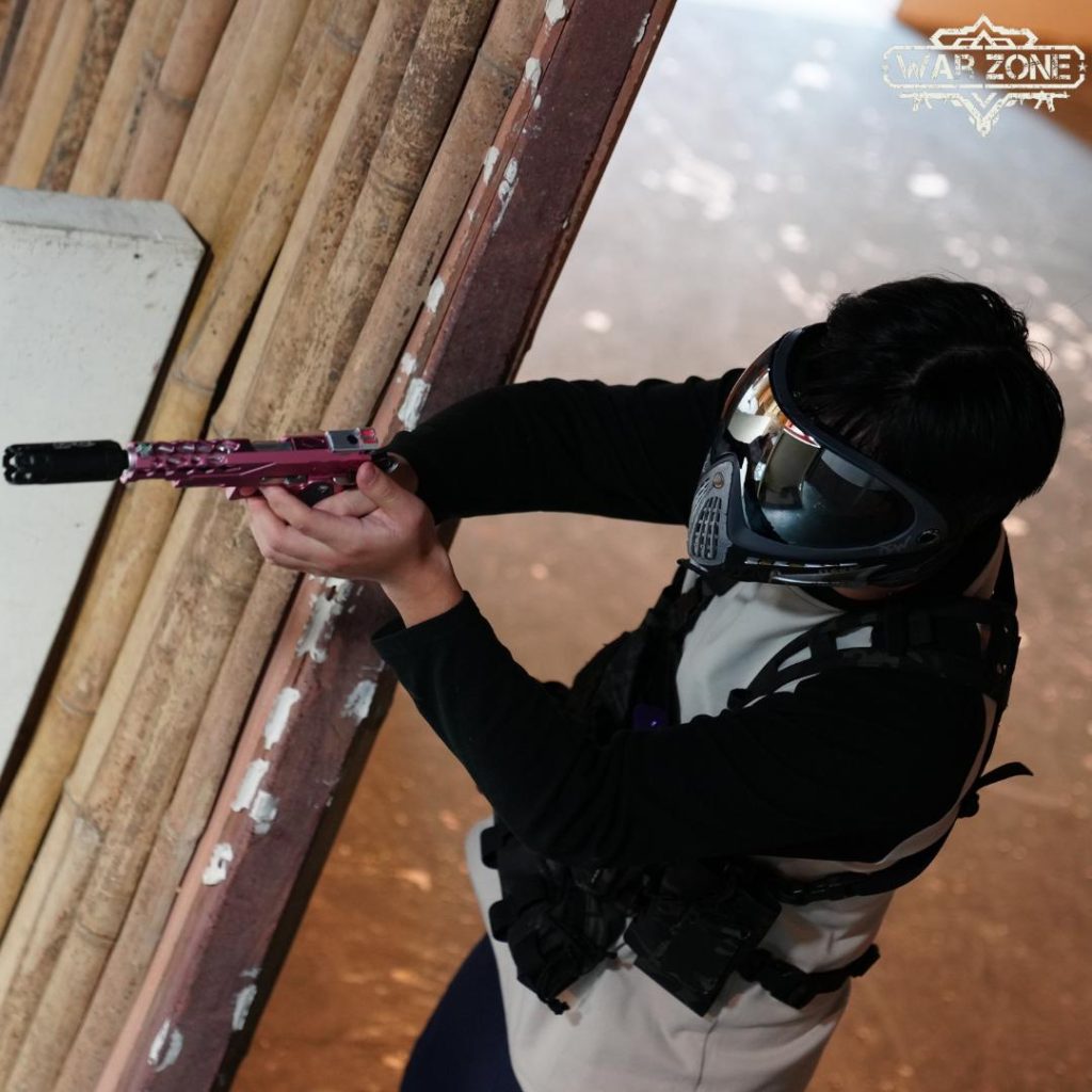 Single wargame player sniping behind a wall